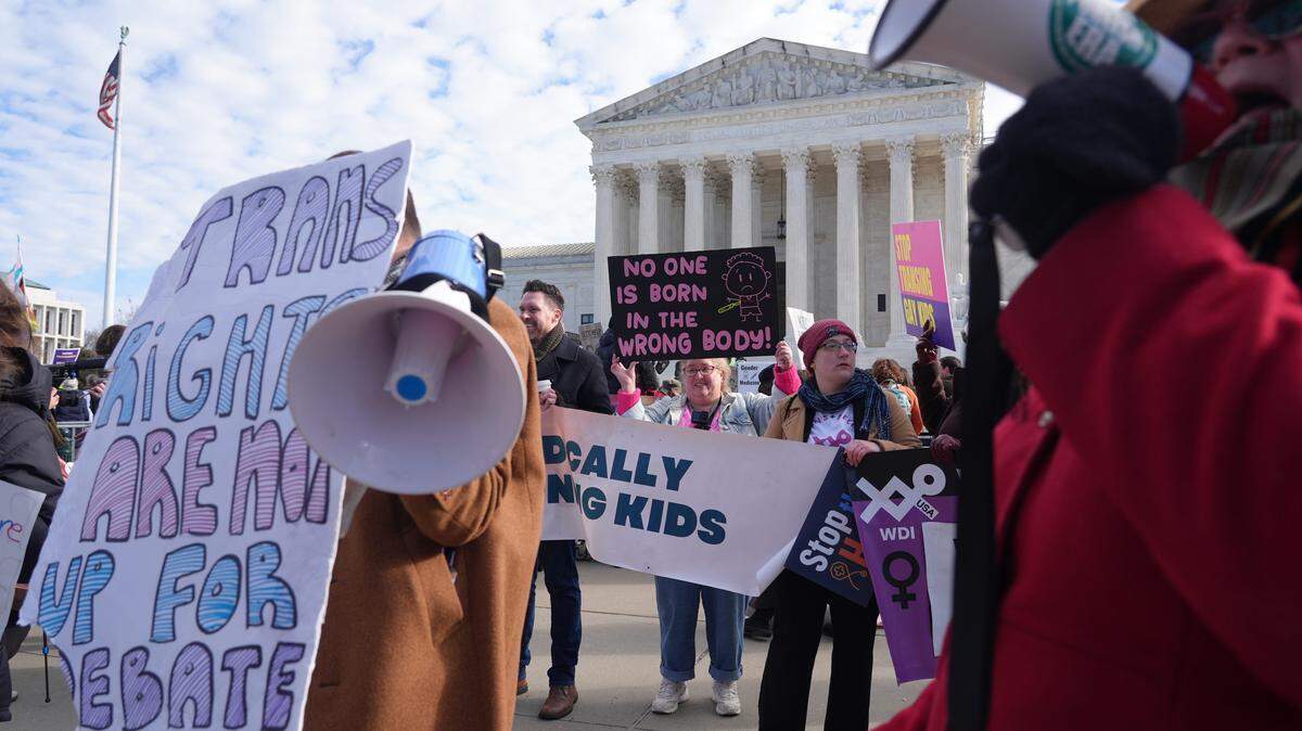 Protesters demonstrated outside the U.S. Supreme Court on Dec. 4, 2024, as justices considered states' ability to prevent transgender adolescents from using puberty blockers and hormone therapy.
