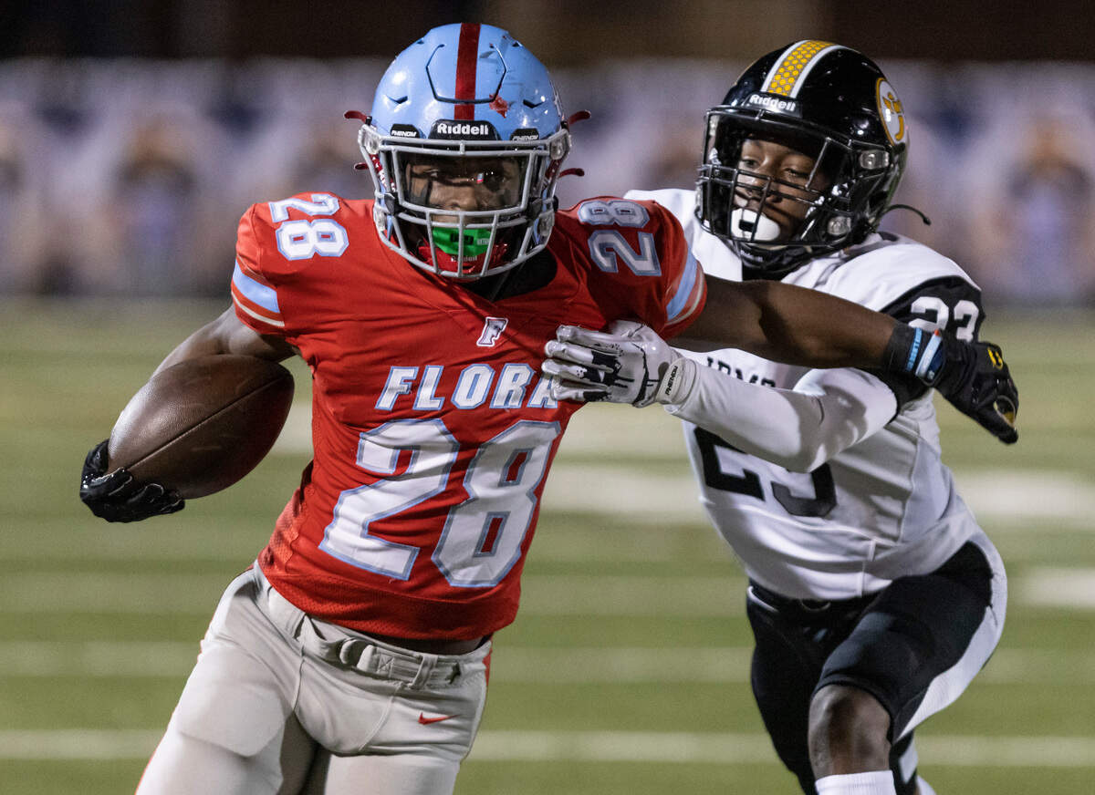 Markel Townsend (28) of AC Flora fends off the tackle of Matthew Blocker (23) of Irmo at Memorial Stadium on Oct. 14, 2022.