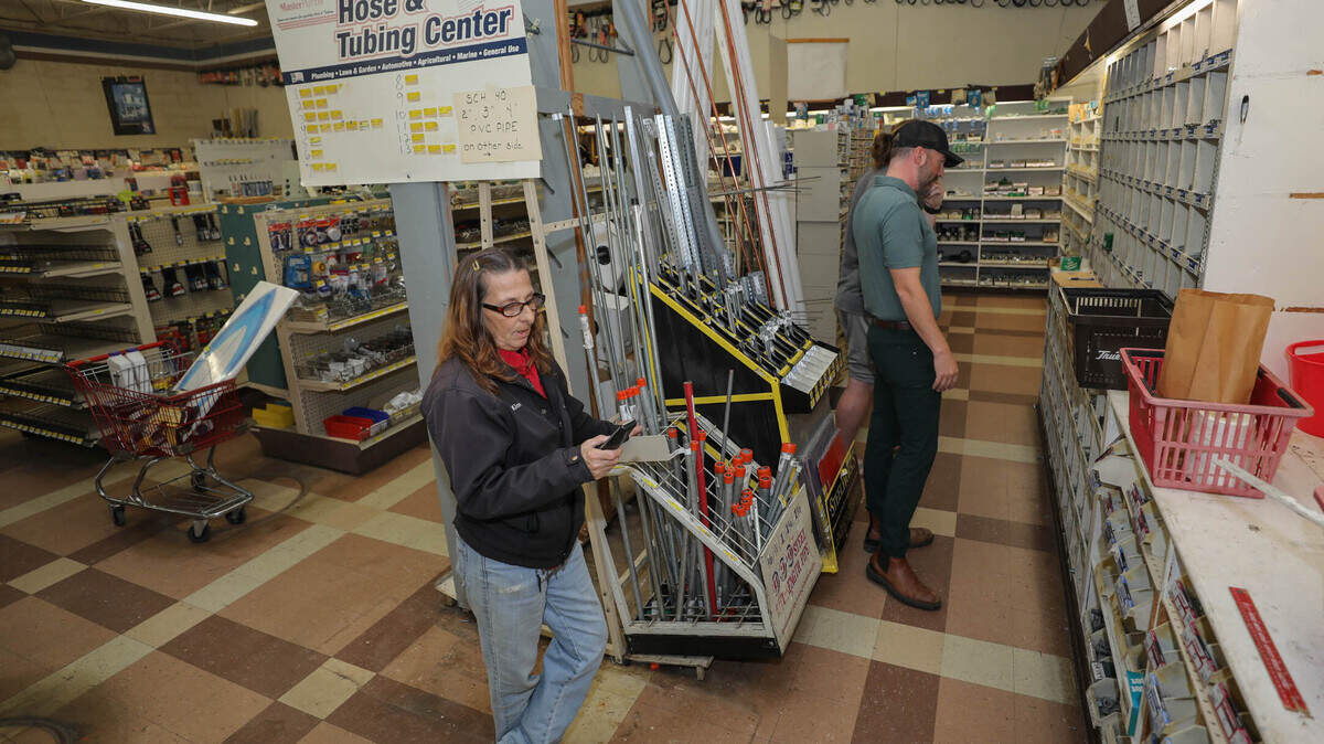 Kim Smart helps Kyle Schoenleber with a purchase at Wood True Value Hardware store on Broad River Rd in Columbia. The store is closing its doors after more than 40 years in business.