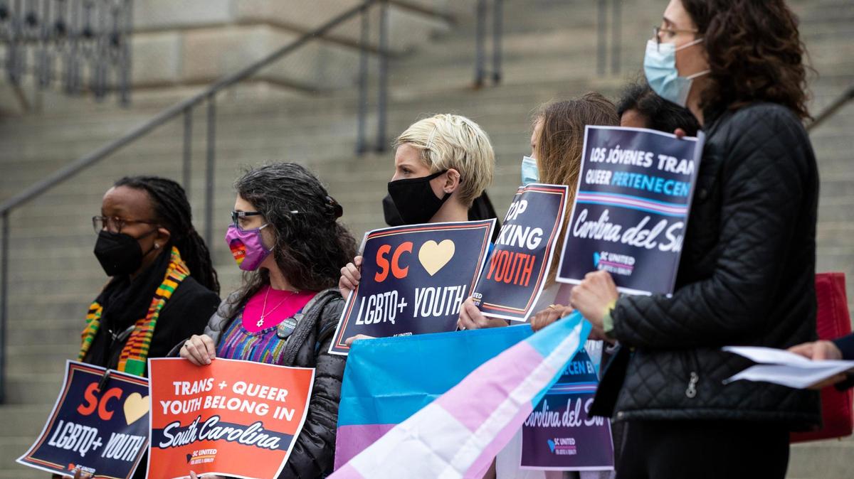Protestors demonstrate outside the State House against the “Save Women’s Sports Act,” which would ban transgender girls from competing in school sports on Thursday, March 10, 2022. 