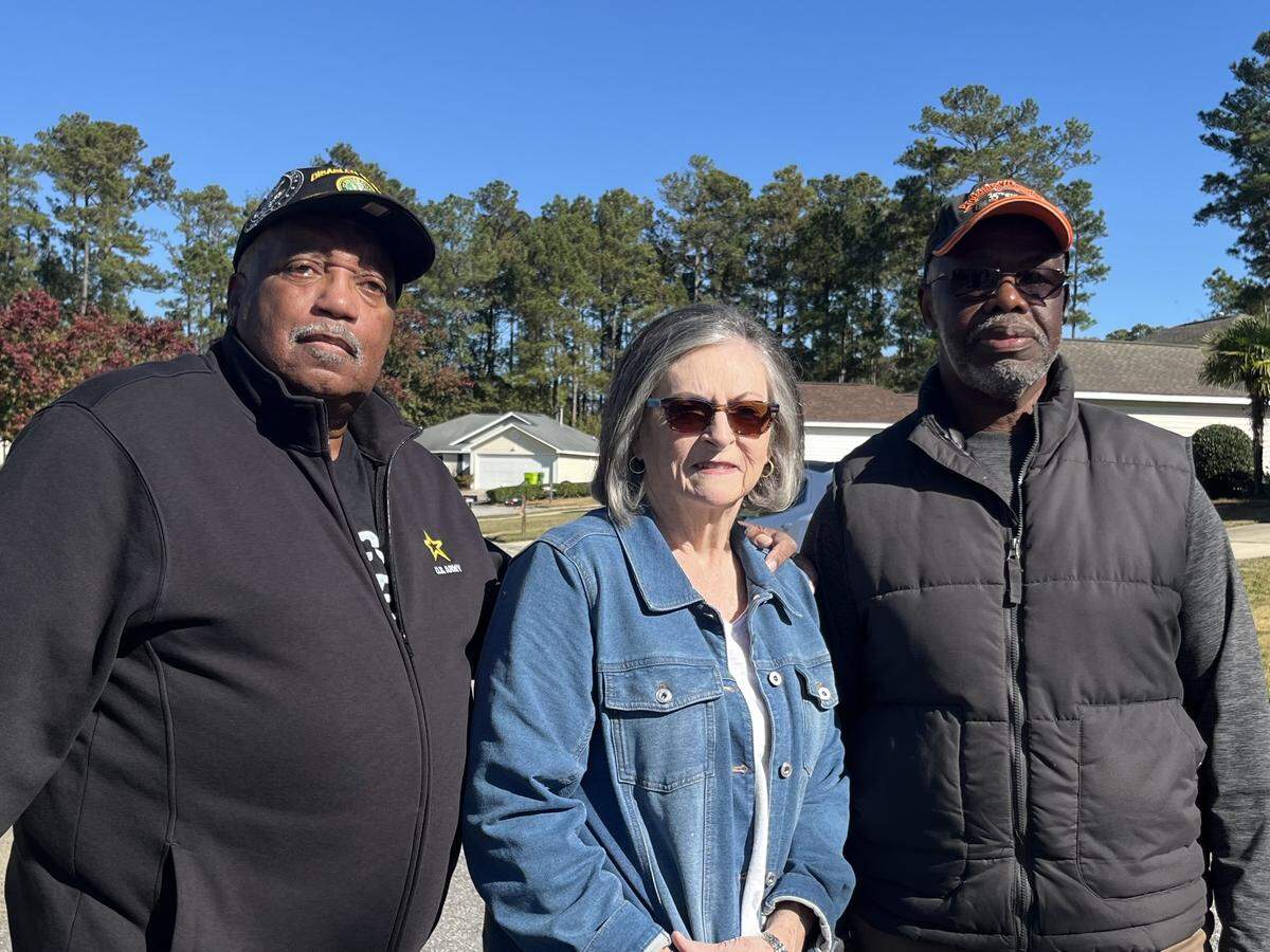 Tony Chaviz, Debbie Foster and Charles Scriven, members the Creekside in Reflections Homeowners’ Association stand near their homes in Lower Richland on Nov. 14, 2025. The HOA is suing Richland 1 for inverse condemnation over flooding issues.