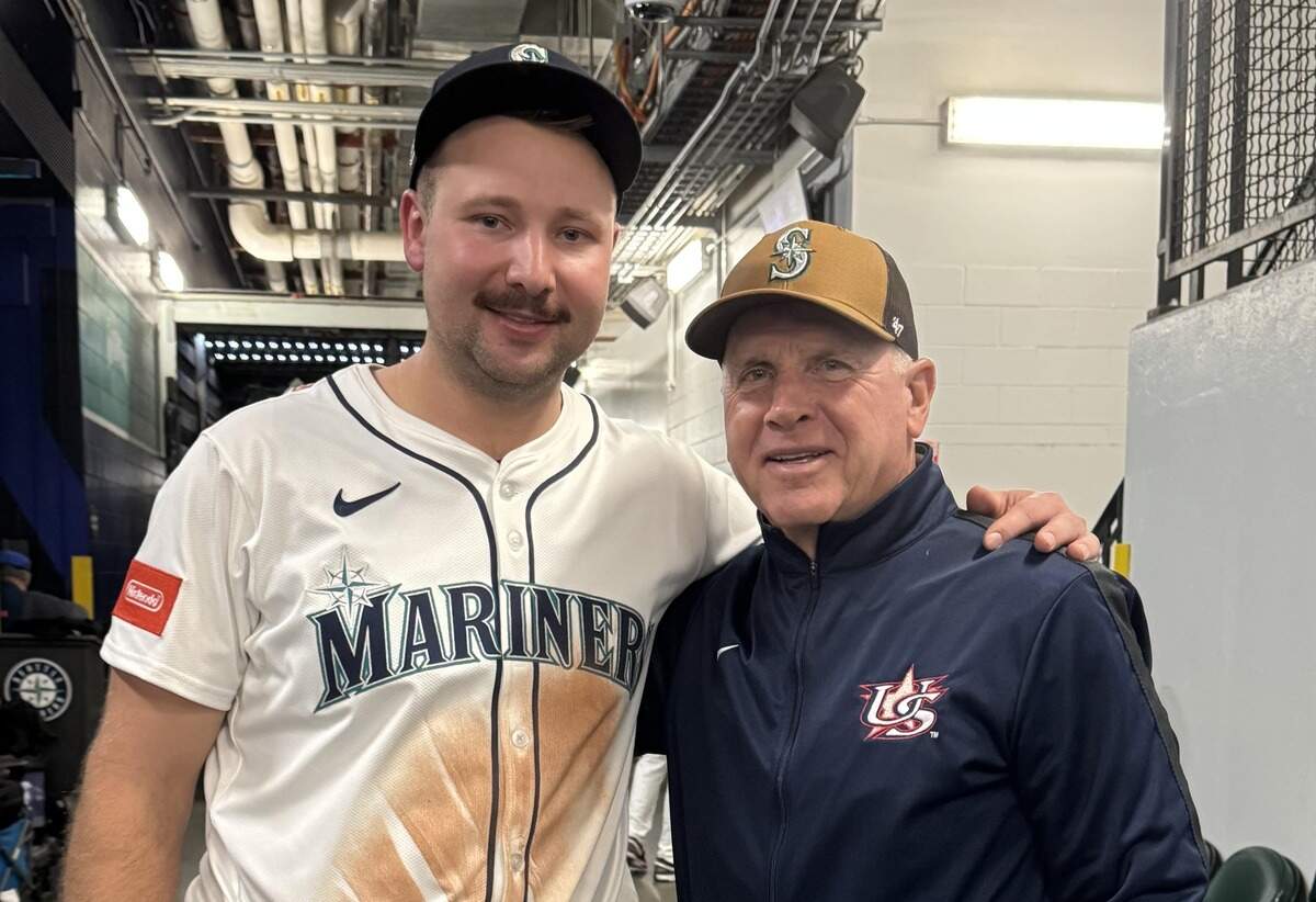 Former Clemson baseball coach Jack Leggett visits with the Seattle Mariners’ Cal Raleigh after an ALDS home game vs. the Detroit Tigers this month.