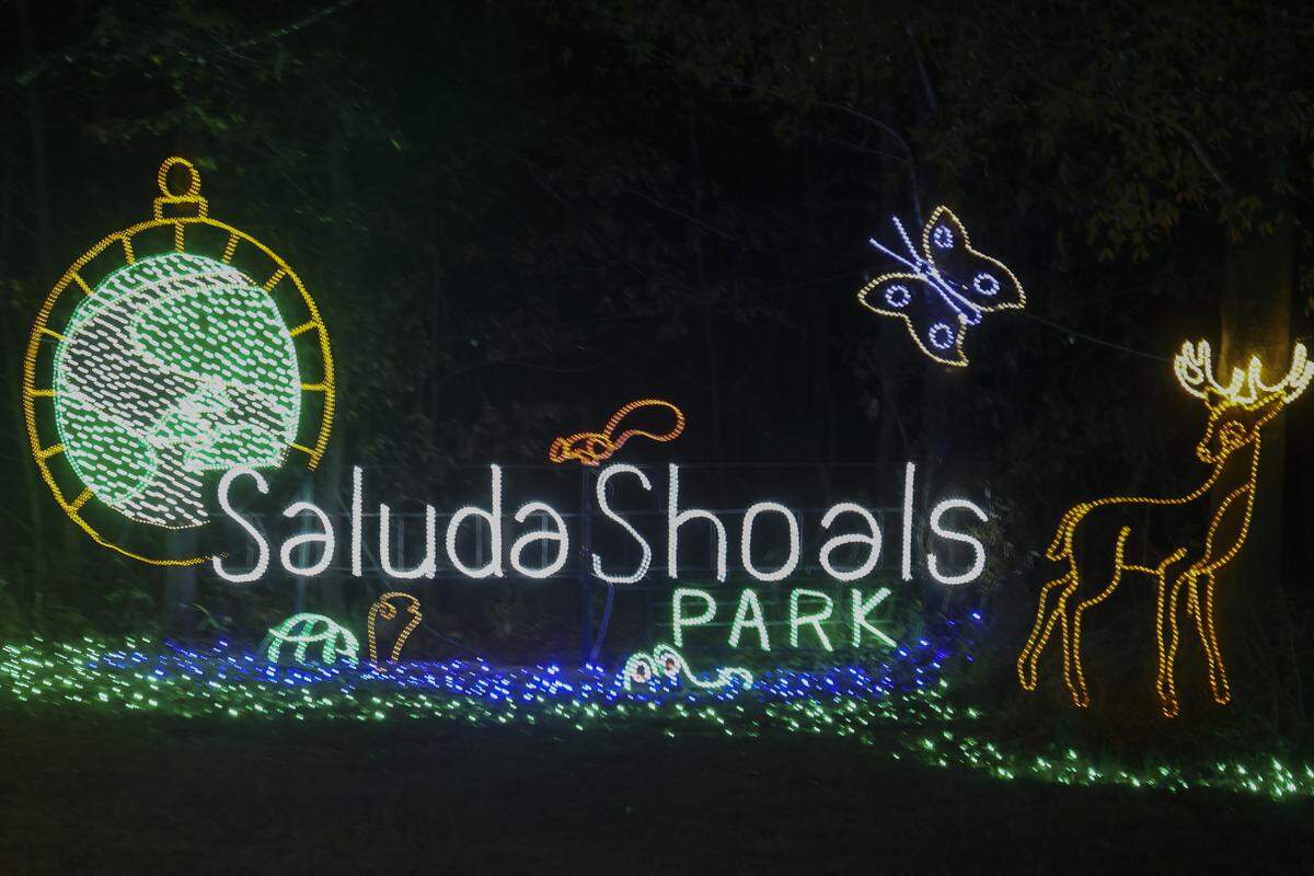 A festive holiday scene unfolds in Saluda Shoals Park as motorists drive through during the Holiday Lights on the River on Wednesday, Dec. 3, 2025. The annual event features three miles of lighted animated displays, a walking trial with a laser light show, and hay rides.