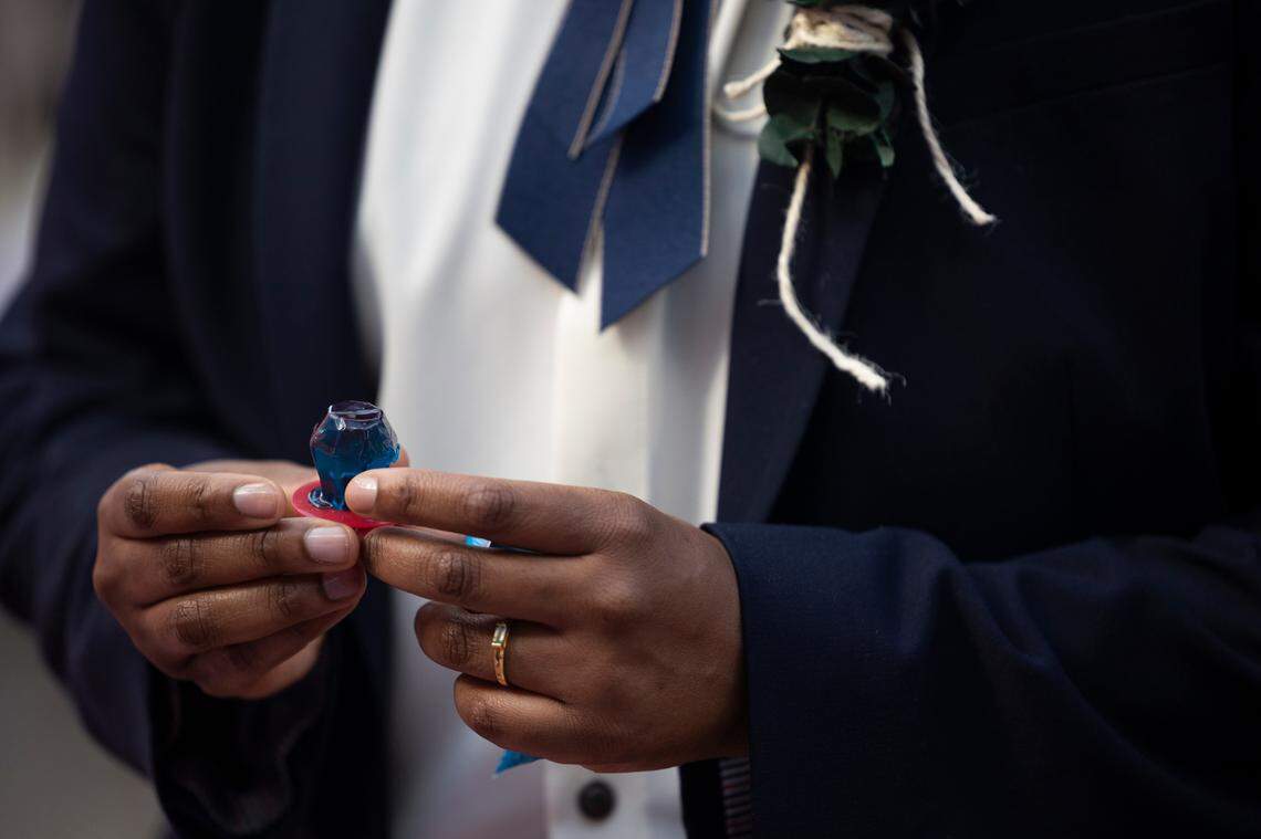 Mahkia Greene presents a ring to Klo Hampton during their wedding at Y’all-Mart, a quarterly art fair series, at Art Bar in Columbia, South Carolina on Sunday, February 9, 2025. The couple originally planned to have their wedding in 2026, but decided to move the wedding date forward as a safety precaution.
