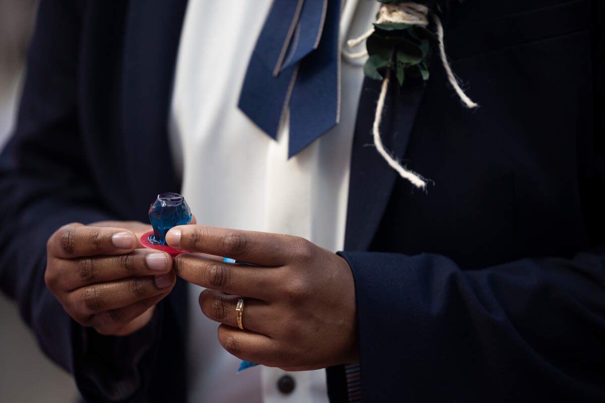Mahkia Greene presents a ring to Klo Hampton during their wedding at Y’all-Mart, a quarterly art fair series, at Art Bar in Columbia, South Carolina on Sunday, February 9, 2025. The couple originally planned to have their wedding in 2026, but decided to move the wedding date forward as a safety precaution.