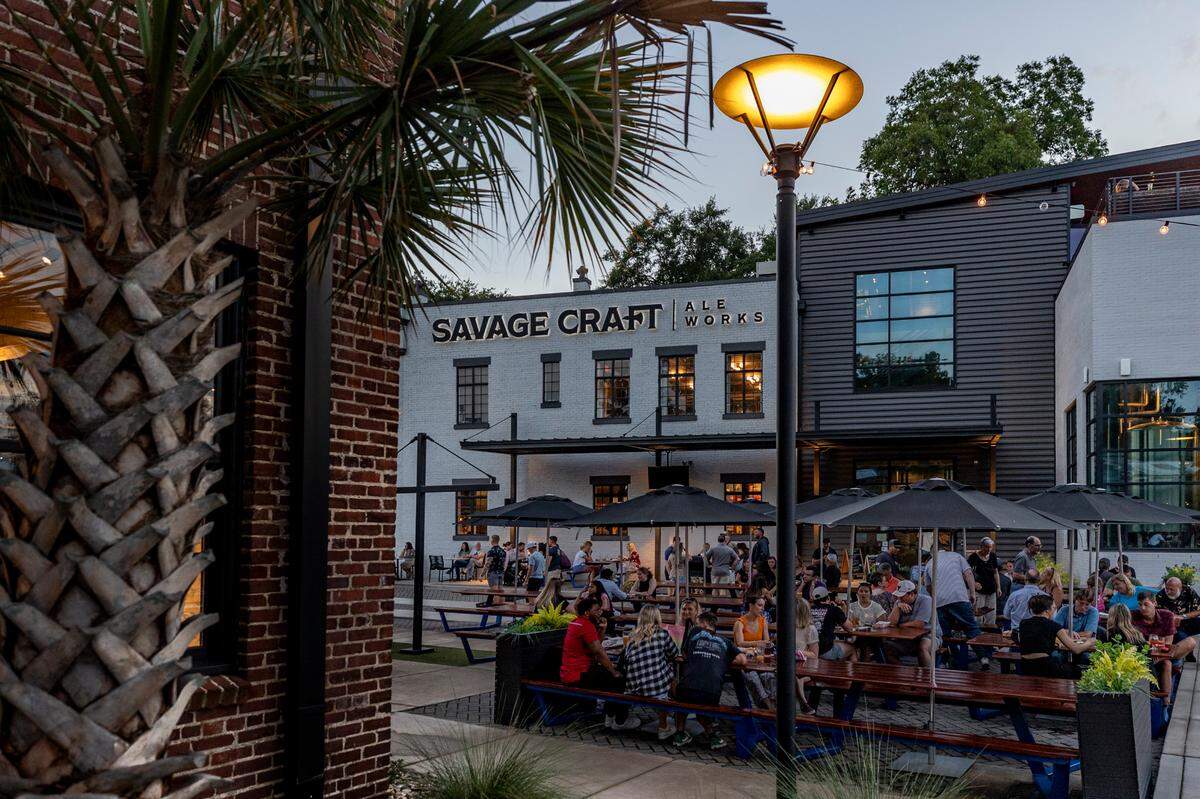 People listen to the Abbey Elmore Band on the Biergarten stage at Savage Craft Ale Works in West Columbia on Friday, July 26, 2024.