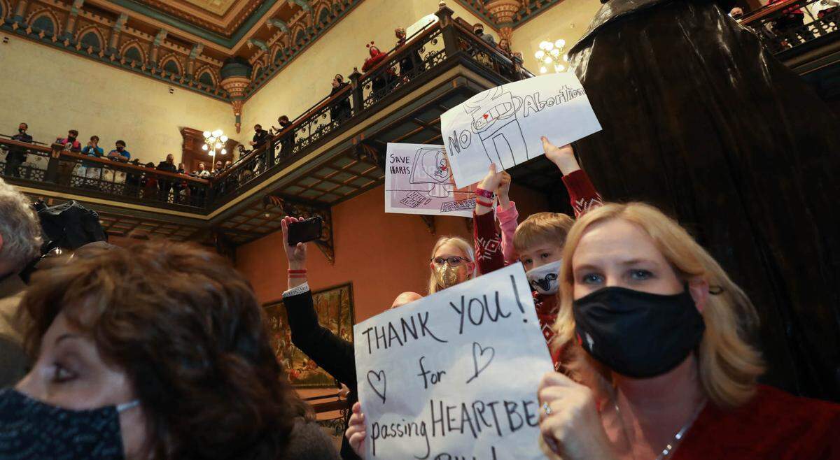Pro-life supporters including Amy Rummage, right, from Fort Mill, S.C. celebrate the signing of the fetal heartbeat bill into law during a ceremony at the Statehouse on Thursday, Feb. 18, 2021.