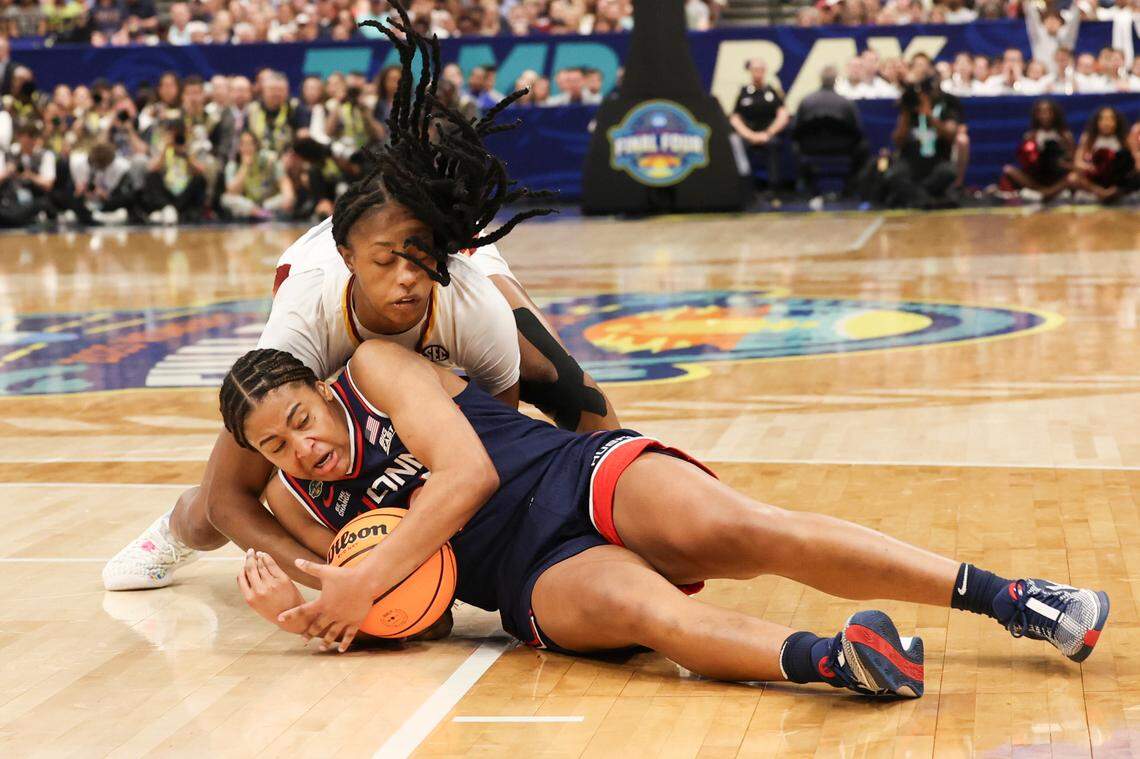 University of South Carolina’s Joyce Edwards (8) tussles with University of Connecticut’s Sarah Strong (21) for a loose ball during the first half of action against the University of Connecticut for the NCAA National Championship at Amalie Arena in Tampa, Fla. on Sunday, April 6, 2025.