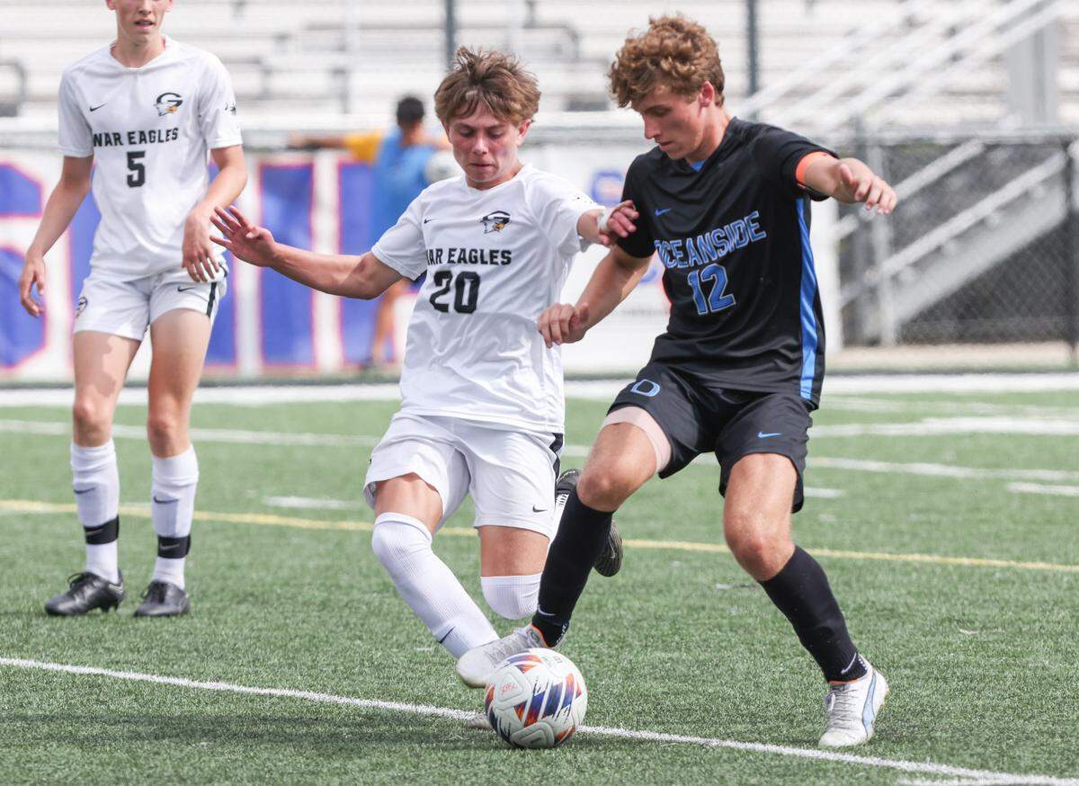 Noah Mitchell (20) of Gray Collegiate gets tripped up by Dominick D’Elia (12) of Oceanside Collegiate during the SCHSL Class 2A Boys State Soccer Championship between Oceanside Collegiate and Gray Collegiate at Irmo High School on Saturday, May 13, 2023.
