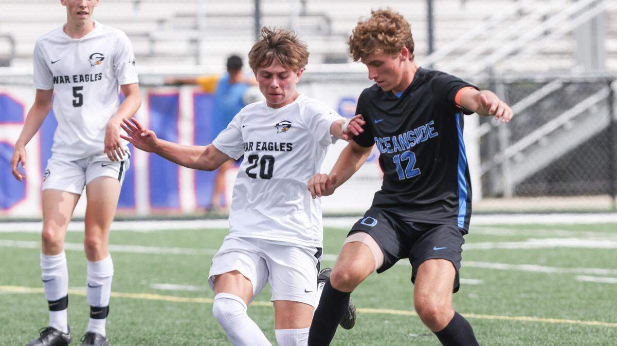 Noah Mitchell (20) of Gray Collegiate gets tripped up by Dominick D’Elia (12) of Oceanside Collegiate during the SCHSL Class 2A Boys State Soccer Championship between Oceanside Collegiate and Gray Collegiate at Irmo High School on Saturday, May 13, 2023.