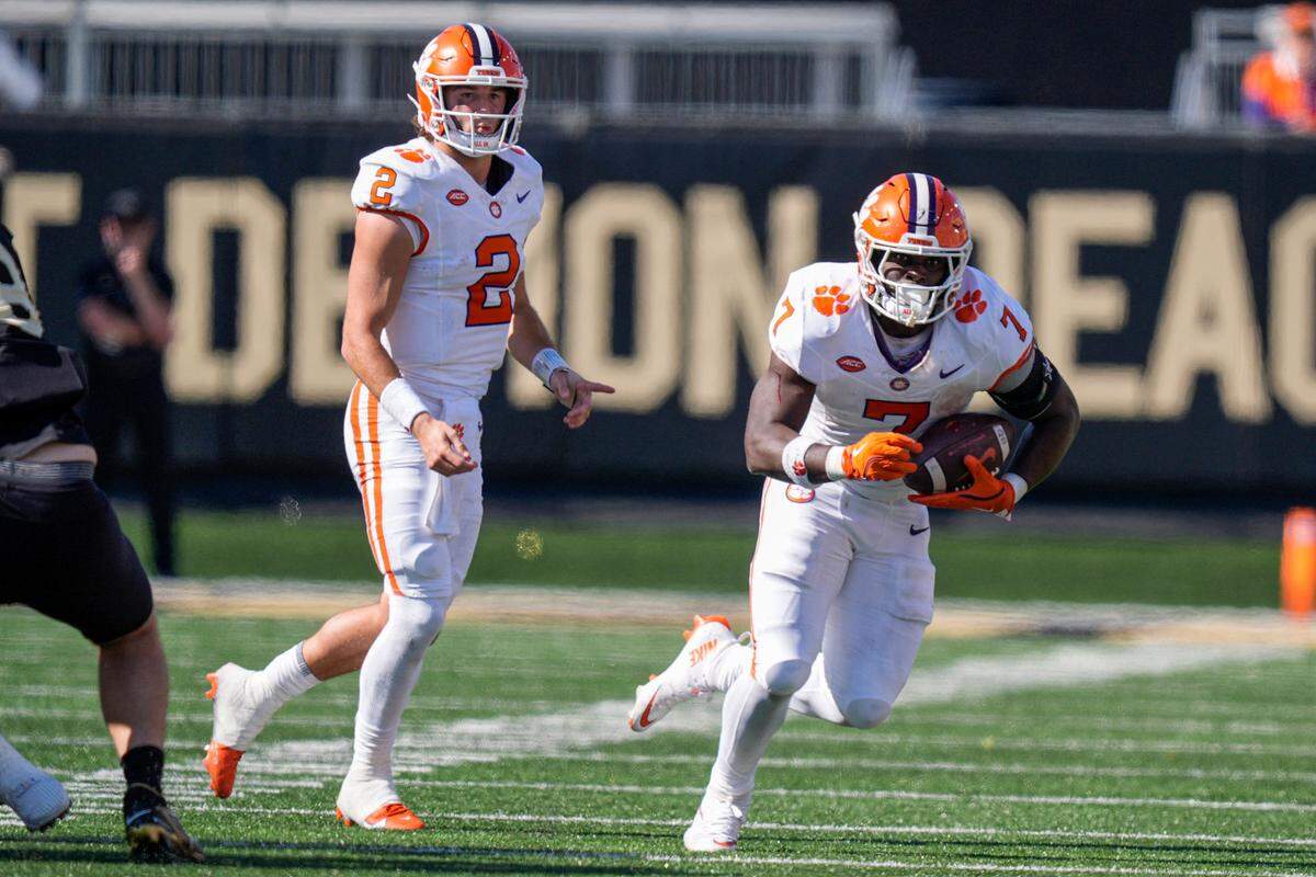 Oct 12, 2024; Winston-Salem, North Carolina, USA; Clemson Tigers quarterback Cade Klubnik (2) watches running back Phil Mafah (7) run after the handoff against the Wake Forest Demon Deacons during the second half at Allegacy Federal Credit Union Stadium.