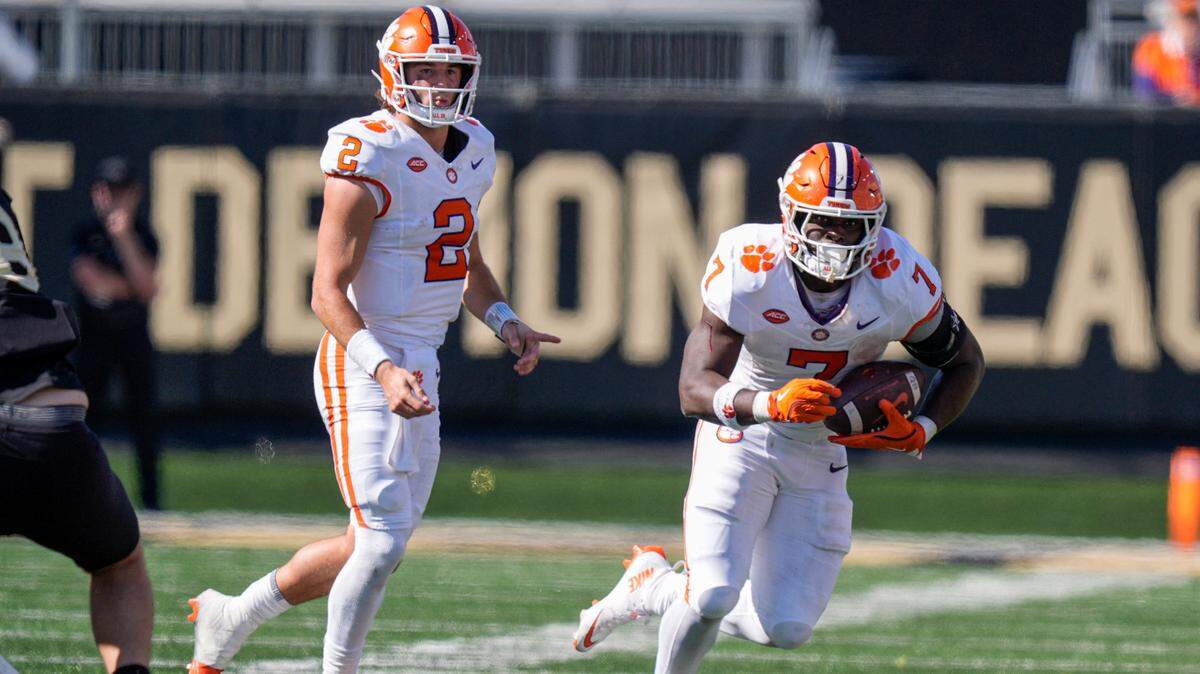 Oct 12, 2024; Winston-Salem, North Carolina, USA; Clemson Tigers quarterback Cade Klubnik (2) watches running back Phil Mafah (7) run after the handoff against the Wake Forest Demon Deacons during the second half at Allegacy Federal Credit Union Stadium.