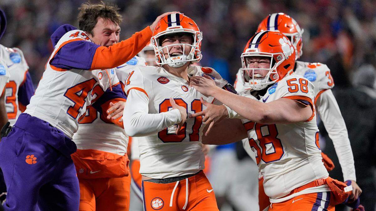 Clemson Tigers place kicker Nolan Hauser (81) celebrates with teammates after making a 56-yard field goal as time expired in the fourth quarter to win the 2024 ACC Championship game against the Southern Methodist Mustangs at Bank of America Stadium.