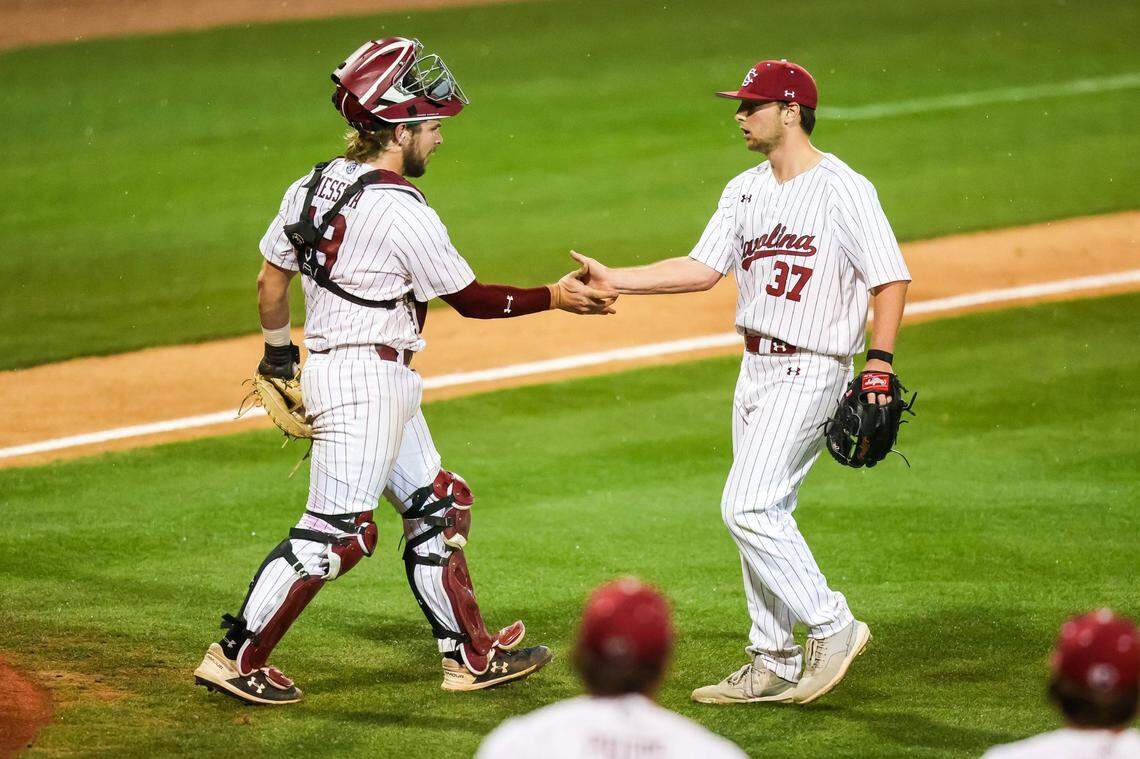 South Carolina pitcher Chris Veach (37) and catcher catcher Cole Messina (19) celebrate the win following the game between the South Carolina Gamecocks and the Penn Quakers on Friday, 2/24/23 at Founders Park in Columbia, SC.