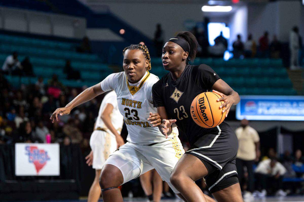 Lower Richland guard Jhnai Sumter (23) drives the ball around a defender in the first half during the Lower Richland vs. North Augusta SCHSL Class 4A Lower State girls basketball championship on March 3, 2025 in Florence, South Carolina.