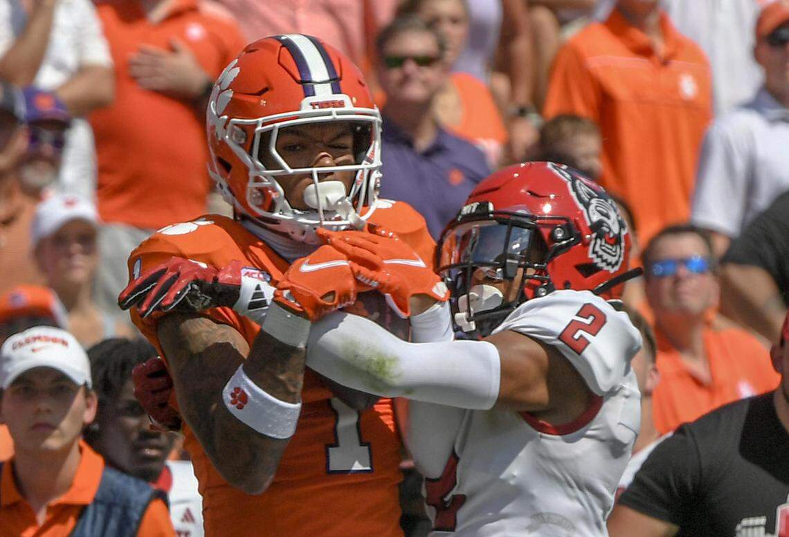 Sep 21, 2024; Clemson, South Carolina, USA; Clemson Tigers wide receiver T.J. Moore (1) catches a pass against North Carolina State Wolfpack cornerback Brandon Cisse (2) during the first quarter at Memorial Stadium.