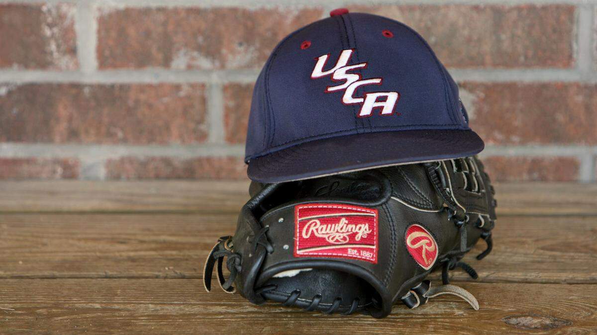 A USC Aiken baseball team member’s glove and hat sit on the bench in the dugout during practice.