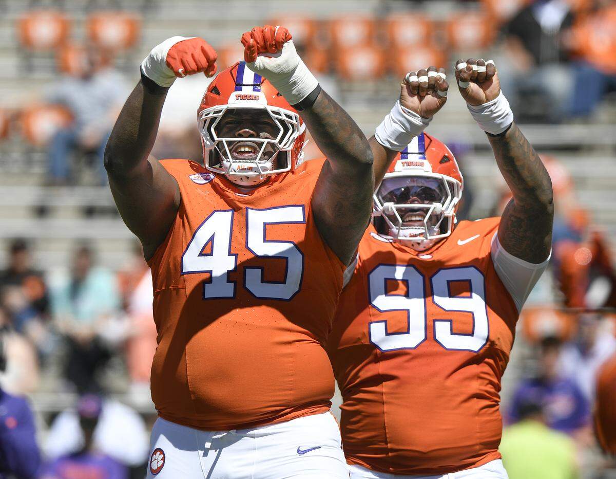 Clemson defensive tackles Vic Burley (45) and Markus Strong (99) react after a defensive stop during the annual spring game Saturday, March 28, 2026 at Clemson's Memorial Stadium. Bart Boatwright/For The State