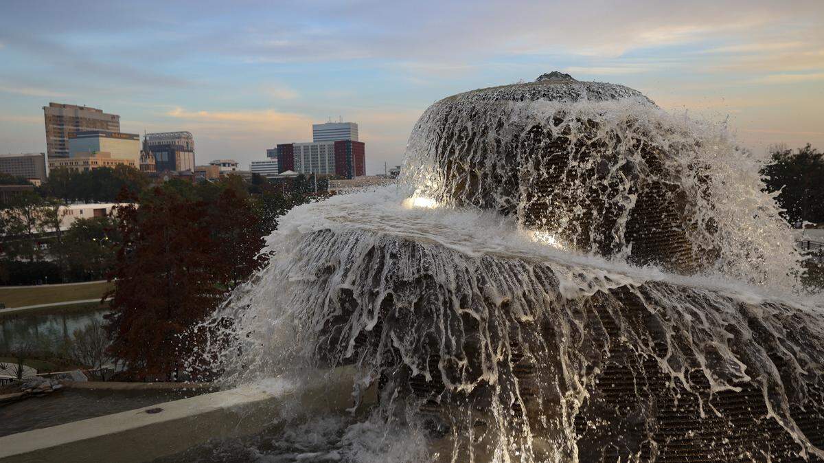 The downtown Columbia skyline shines beyond the fountain at Finlay Park on Thursday, Nov. 20, 2025.