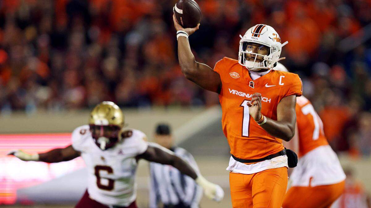 Oct 17, 2024; Blacksburg, Virginia, USA; Virginia Tech Hokies quarterback Kyron Drones (1) throws a touchdown during the second quarter against the Boston College Eagles at Lane Stadium.