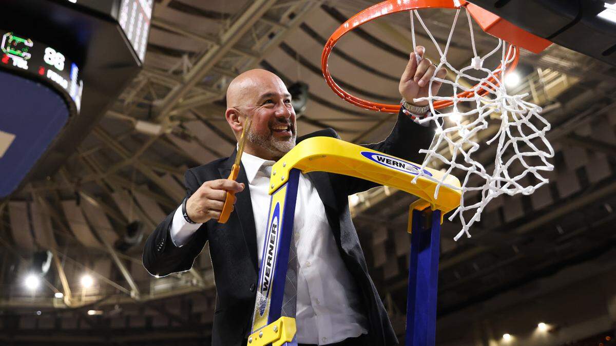 South Carolina Gamecocks assistant coach Fred Chmiel cuts down the net following his team’s win over Maryland in the Elite 8 round of the 2023 NCAA Tournament at Bon Secours Wellness Arena in Greenville on Monday, March 27, 2023.