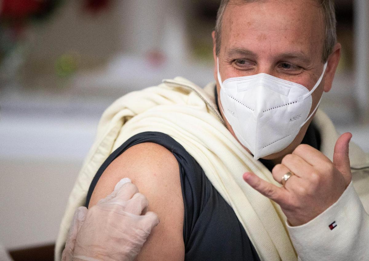 Eric Axelsson receives the first shot of the coronavirus vaccine at Wellmore of Lexington on Wednesday, December 30, 2020. Axelsson works in dinning services and is excited to have extra protection at work and his family.