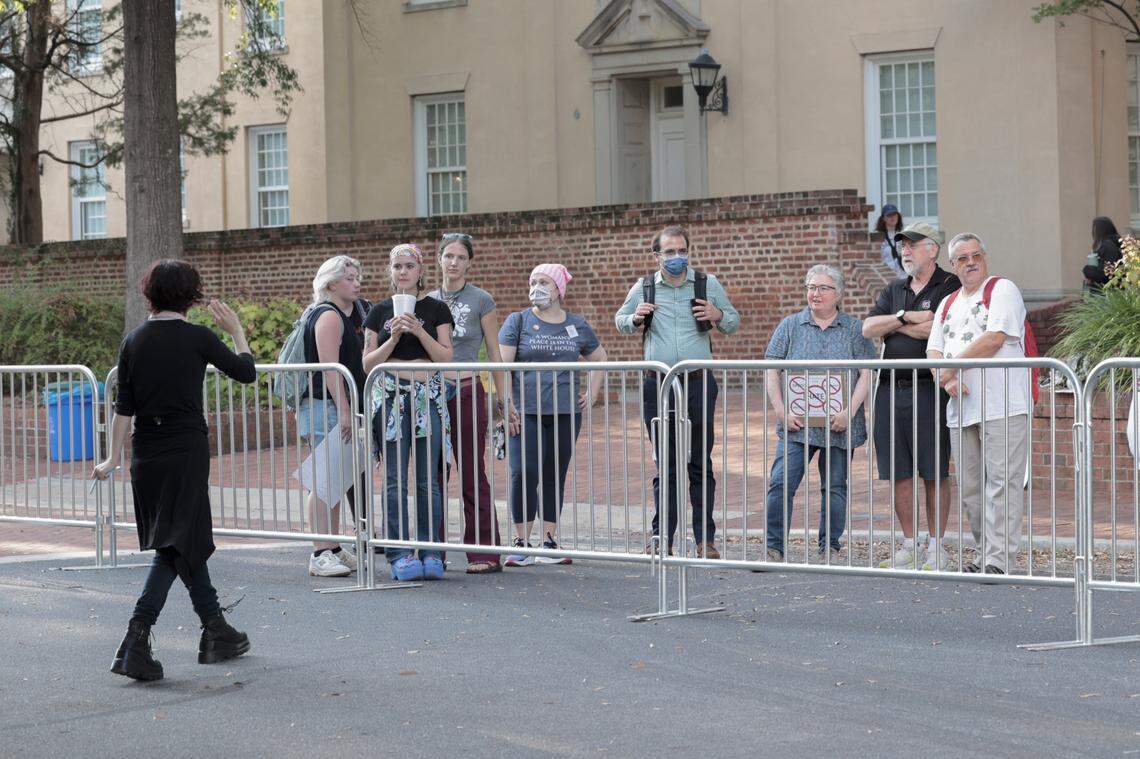 A small group of people stand outside barricades at the University of South Carolina Russel House where Milo Yiannopoulos and Gavin McInnes were speaking.