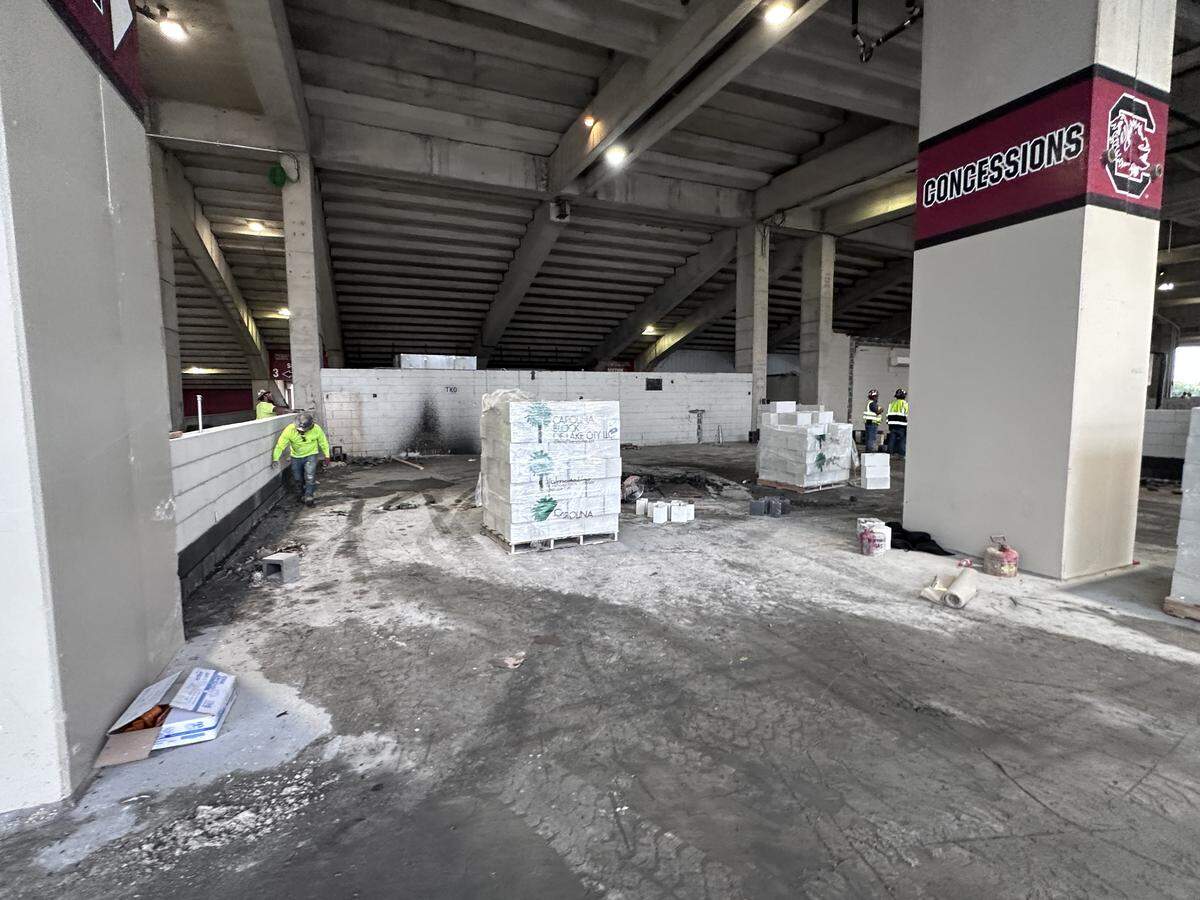 Workers install bricks on the 200 level of the west side of Williams-Brice Stadium for what will be a new bathroom.