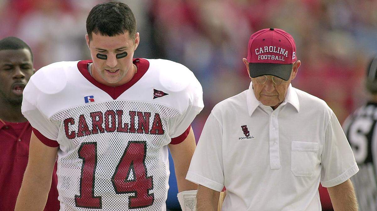 From Oct. 13, 2001, Phil Petty walks along the sidelines talking with head coach Lou Holtz during a road game against Arkansas.