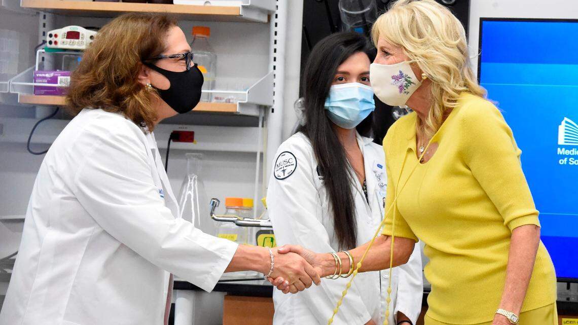 Dr. Nancy Klauber-DeMore, a breast surgical oncologist at MUSC Hollings Cancer Center, left, greets first lady Jill Biden during a presentation on tumor research on Monday, Oct. 25, 2021, in Charleston, S.C. (AP Photo/Meg Kinnard)