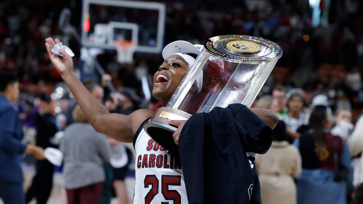 South Carolina’s Raven Johnson (25) celebrates with the SEC Tournament trophy after the Gamecocks beat LSU at Bon Secours Wellness Arena in Greenville on Sunday, Mar. 10, 2024.