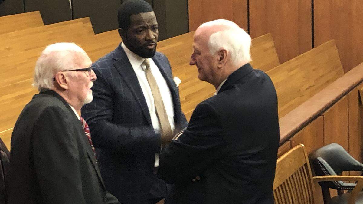 Richard Quinn (l) consults Friday morning with his lawyers Shaun Kent (c) and Rauch Wise