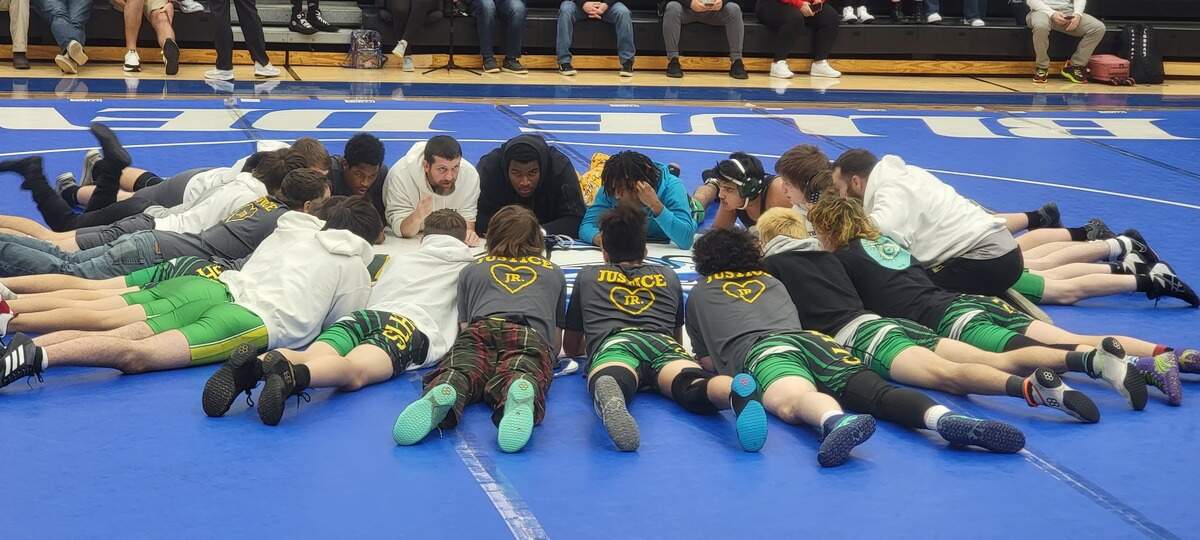 North Central wrestling coach Jason Brazell talks to his team before Saturday’s Class 2A championship match.