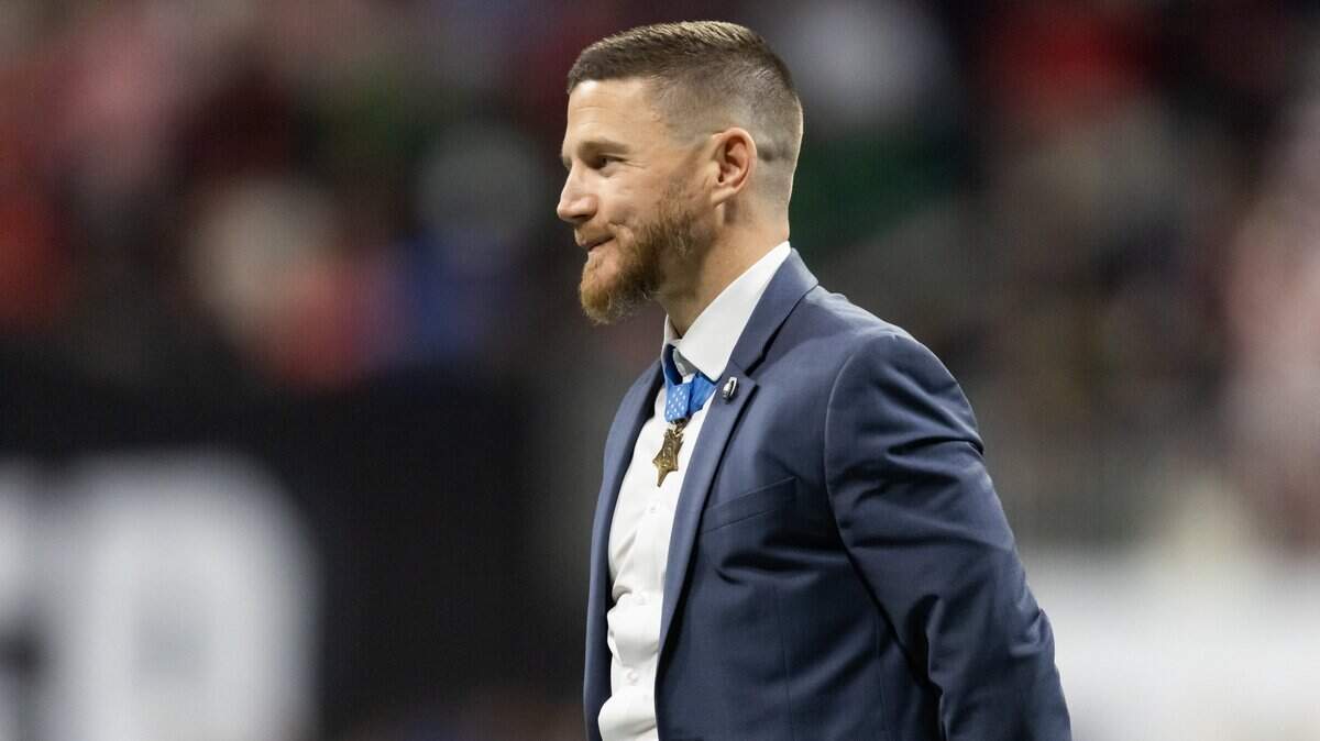 Jan 20, 2025; Atlanta, GA, USA; Medal of Honor recipient retired Marine Cpl. Kyle Carpenter is recognized on the field during the Notre Dame Fighting Irish game against the Ohio State Buckeyes in the CFP National Championship college football game at Mercedes-Benz Stadium. Mandatory Credit: Mark J. Rebilas-Imagn Images