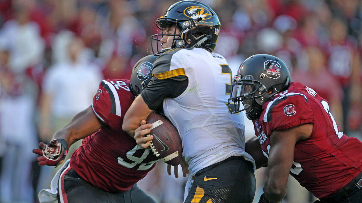 From 2016 game at Williams-Brice: South Carolina Gamecocks defensive lineman D.J. Wonnum (92) and linebacker Jonathan Walton (28) deliver hits on Missouri Tigers quarterback Drew Lock (3).