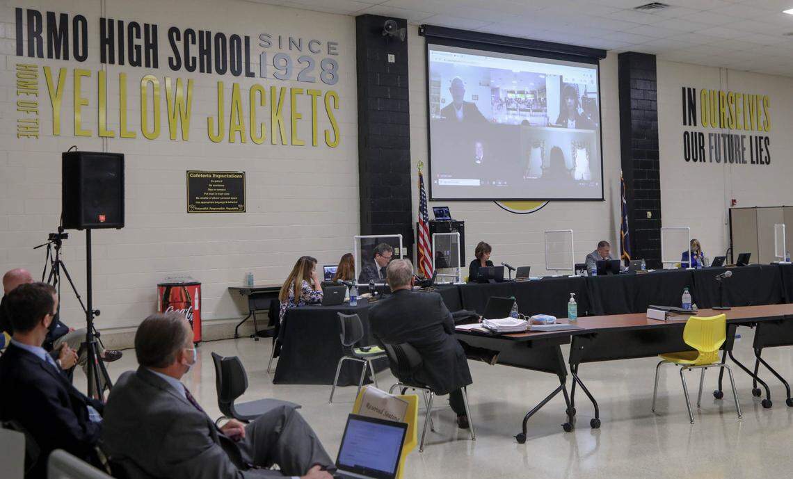 Some members of the Lexington Richland 5 school board connect virtually to the meeting where others are seated far apart with barriers between them. These efforts are to help prevent the spread of the coronavirus. 9/14/20