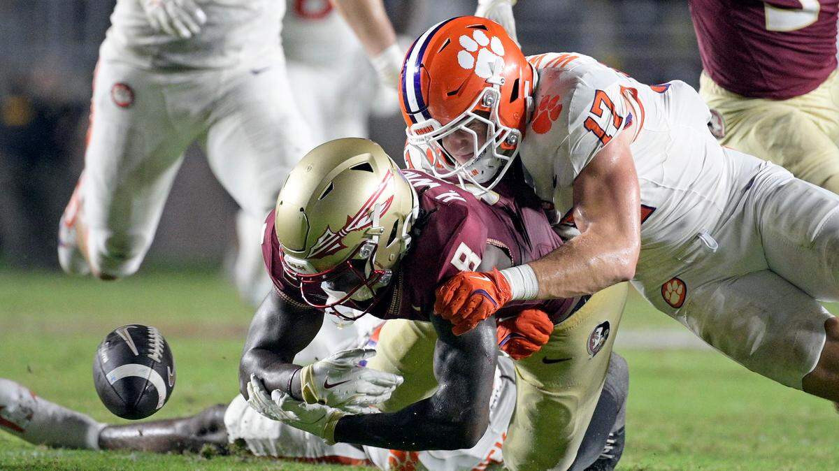 Oct 5, 2024; Tallahassee, Florida, USA; Clemson Tigers linebacker Wade Woodaz (17) forces a fumble by Florida State Seminoles wide receiver Hykeem Williams (8) during the second half at Doak S. Campbell Stadium.
