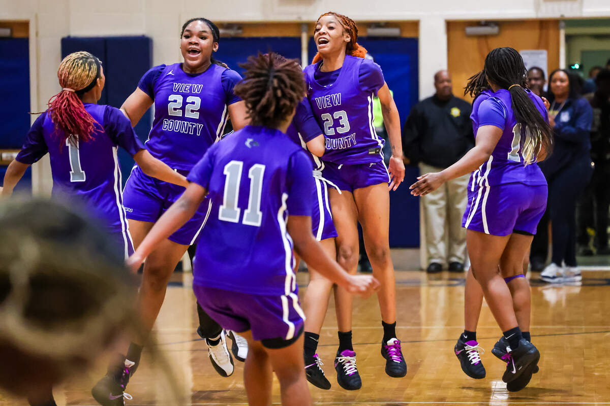 Ridge View High Amiyah Carr (22), Simone Johnson (23) and teammates celebrate a one-point win against Blythewood during their game at Blythewood High School, 2/13/26.