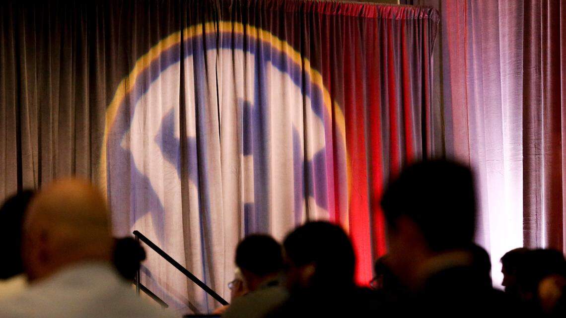 Reporters listen to coaches and players during an NCAA college football news conference at the Southeastern Conference media days, Wednesday, July 21, 2021, in Hoover, Ala.