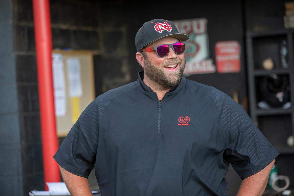 North Greenville head baseball coach Landon Powell by the dugout.