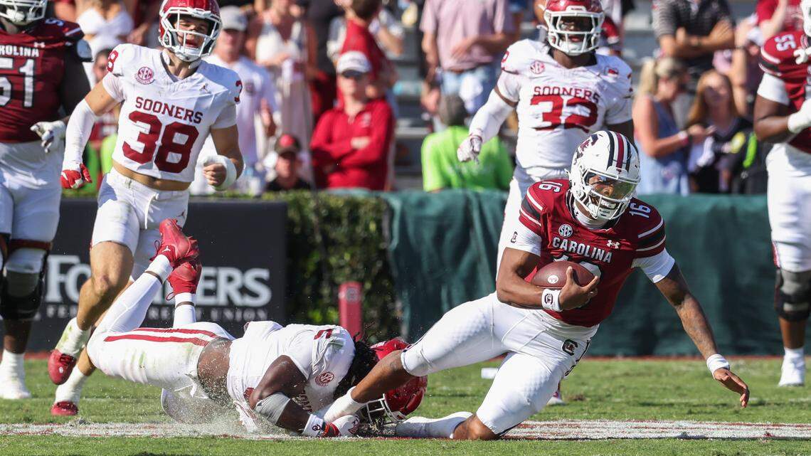 South Carolina quarterback LaNorris Sellers (16) gets tripped up by Oklahoma linebacker Kendal Daniels (5) during the second half of South Carolina’s game against Oklahoma at Williams-Brice Stadium in Columbia on Saturday, October 18, 2025.