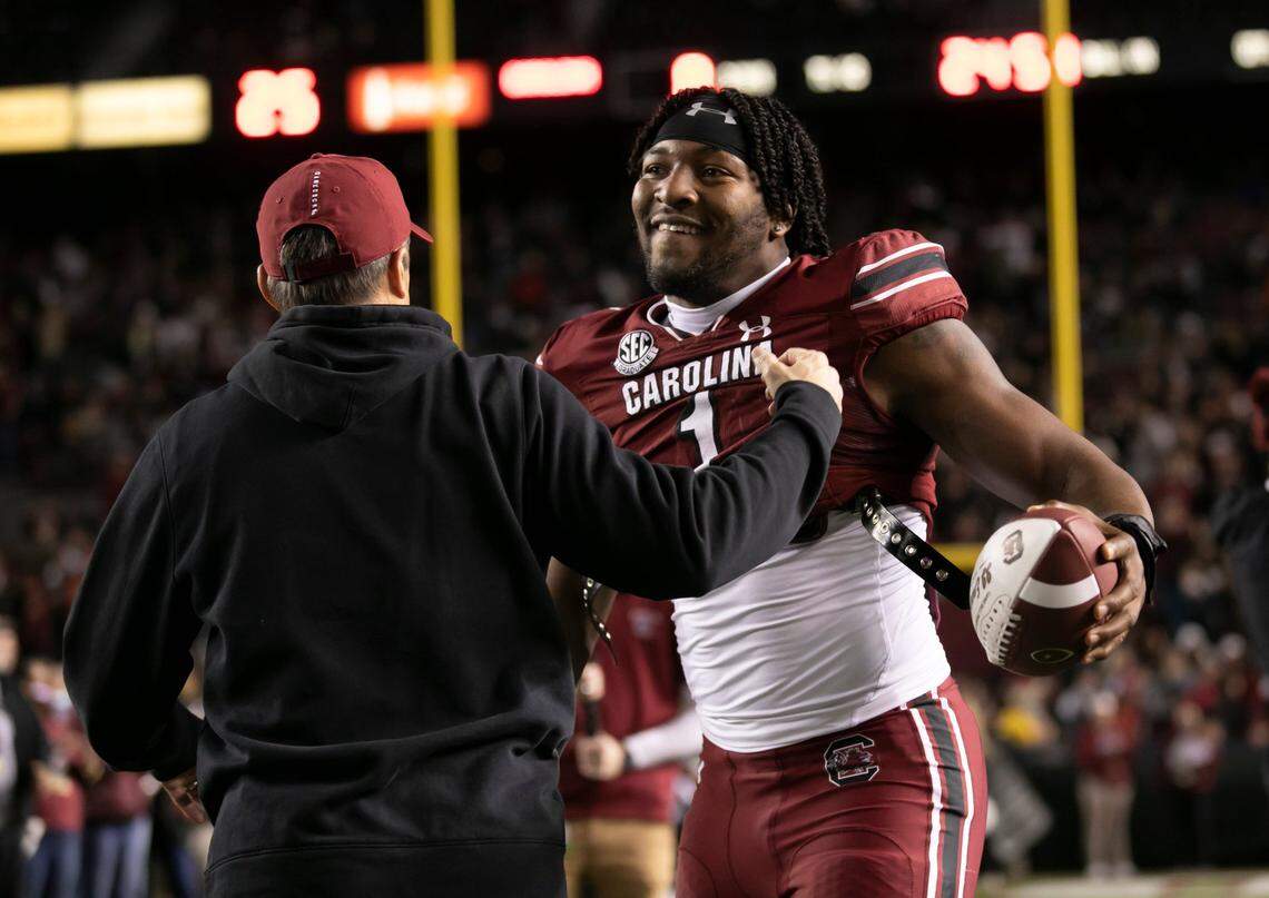 Kingsley “JJ” Enagbare gets a hug from coach Shane Beamer while being recognized on senior night before the Gamecocks’ game against Clemson. Enagbare has been projected as a high NFL Draft pick.
