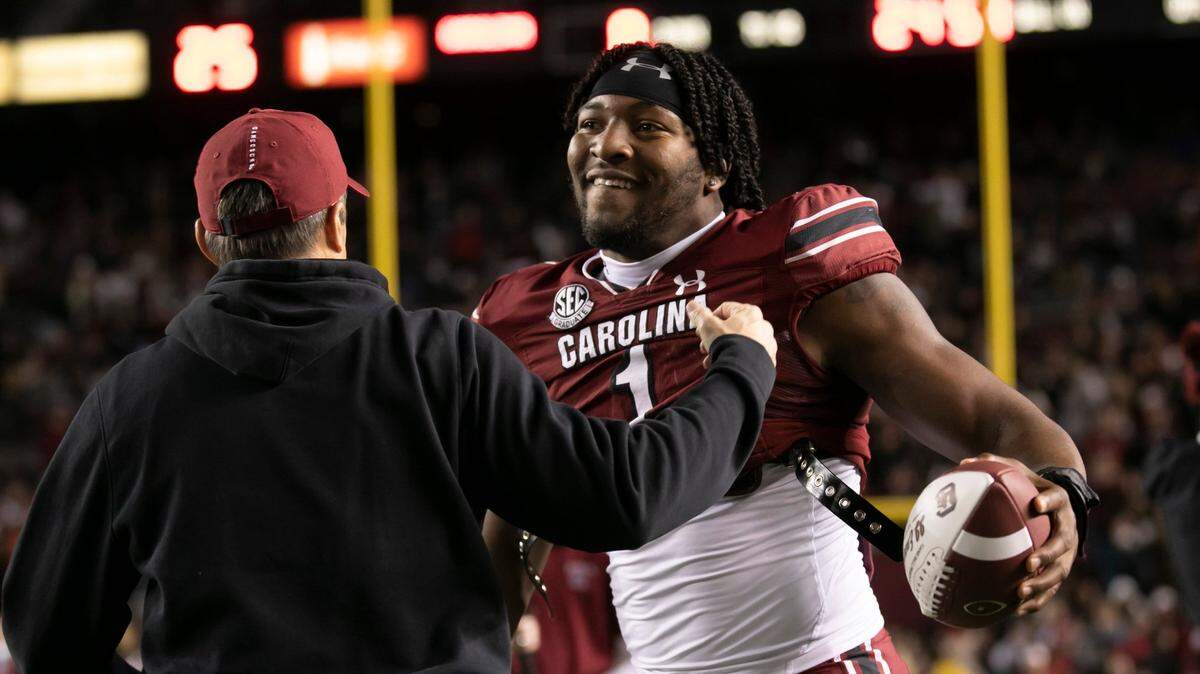 Kingsley “JJ” Enagbare gets a hug from coach Shane Beamer while being recognized on senior night before the Gamecocks’ game against Clemson at Williams-Brice Stadium on Saturday, November 27, 2021.