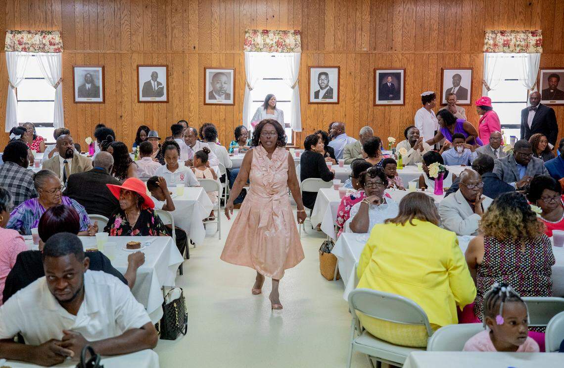 Sister Yvonne Hall, center, walks through the banquet hall making sure everyone is seated for a meal after celebrating the 183rd anniversary service and family day at St. Phillip A.M.E. Church in Eastover, SC. 