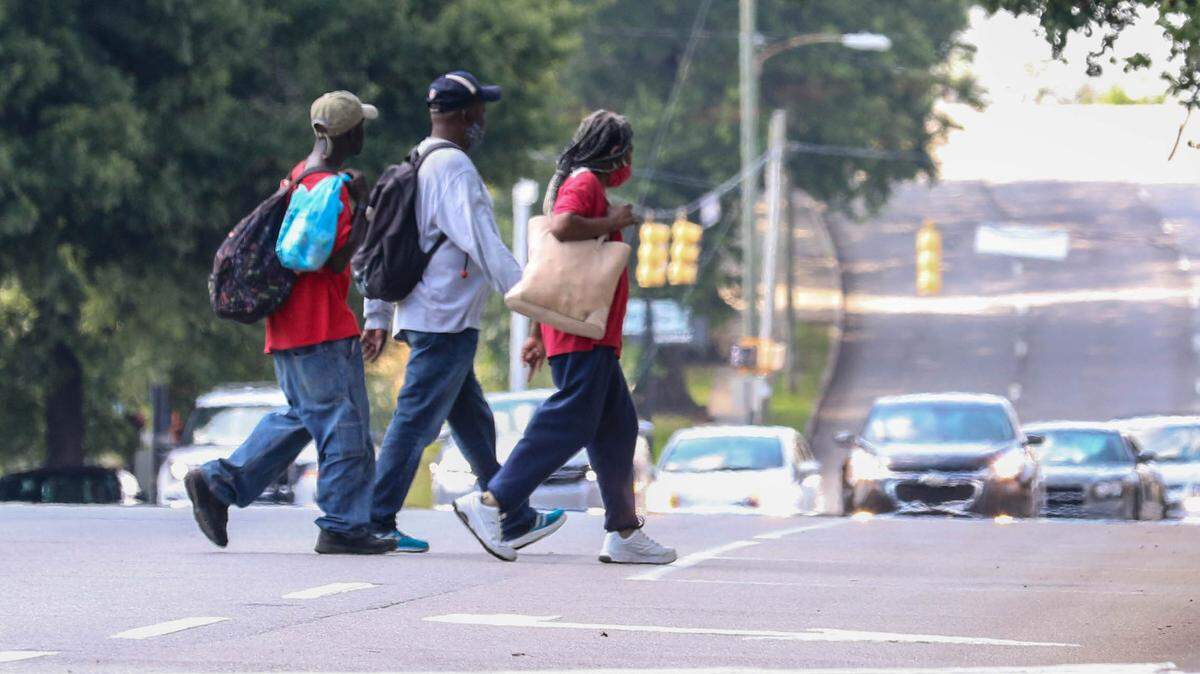 Groups of people walk to Oliver Gospel Mission in downtown Columbia for a meal.