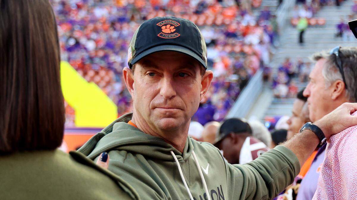Head Coach Dabo Swinney of the Clemson Tigers greets player's parents during warmups before the game against the Furman Paladins at Memorial Stadium on November 22, 2025 in Clemson, South Carolina.