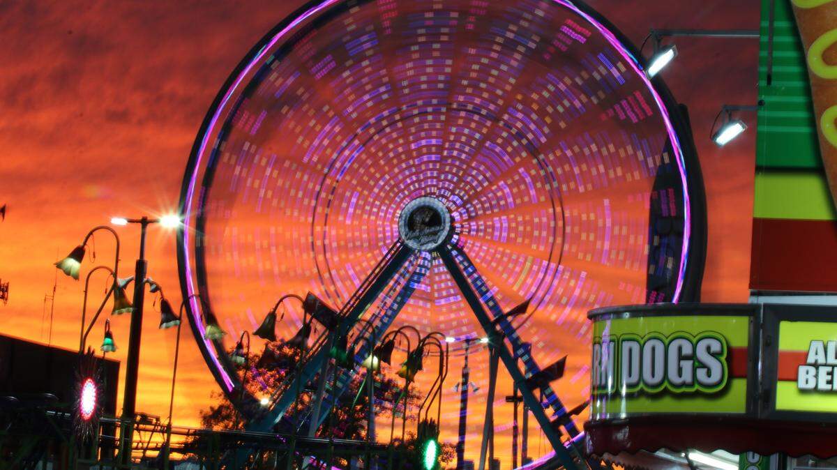 A stunning fall sunset serves as the perfect backdrop to the 150-foot-tall Celebration Wheel on opening day of the South Carolina State Fair.