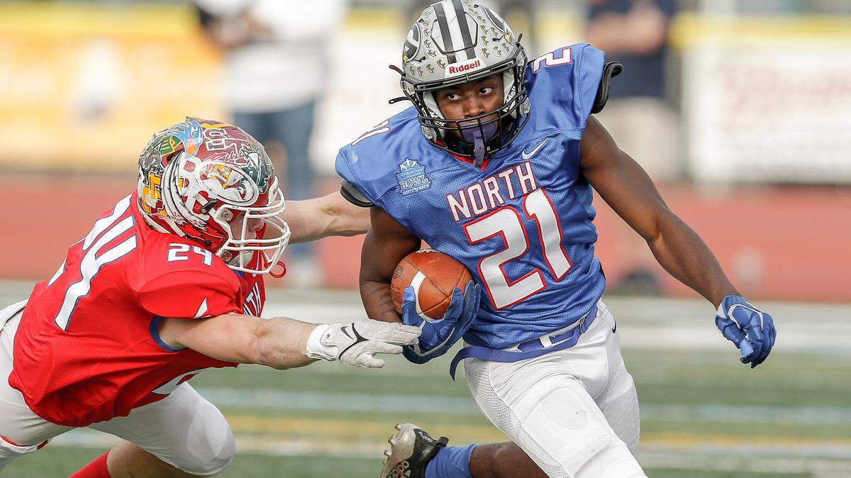 South linebacker Owen Plane of Brookland-Cayce High reaches out for North running back KZ Adams of Grey Collegiate Academy during the 2021 Touchstone Energy Bowl, held at Doug Shaw Memorial Stadium in Myrtle Beach, S.C.