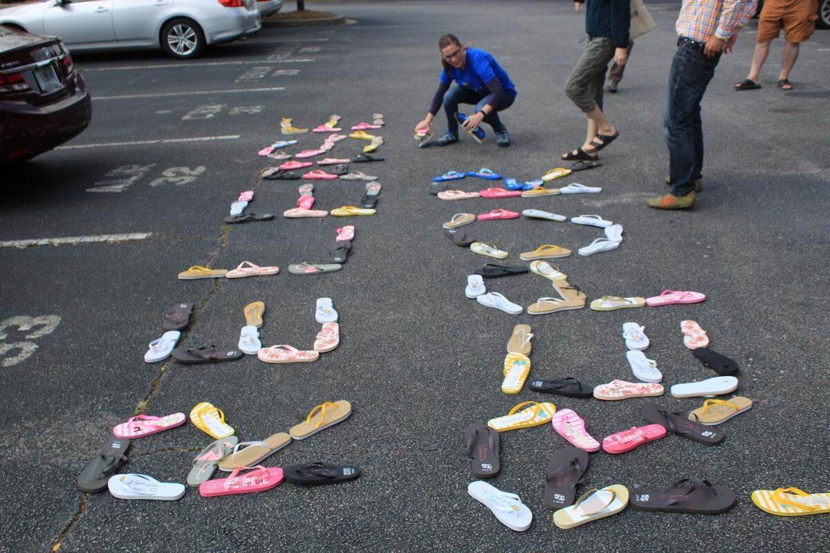 Protestors gather outside of the Columbia office of U.S. Sen. Lindsey Graham, leaving a message in flip flops.