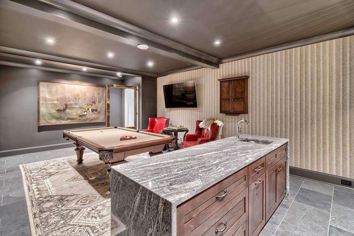 A view of a game room with a bar and billiards table in a $3.9 million home on Lake Murray for sale.